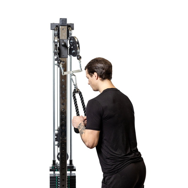 A man in a black shirt uses a Bells of Steel 2 to 1 Cable Attachment Adapter with a rope attachment, preparing for a triceps exercise against a white background.