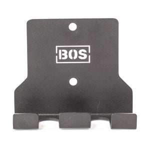 The Bells of Steel Hanging Barbell Holders are black metal, wall-mounted hooks with three prongs and two mounting holes, featuring a white "BOS" logo—perfect for secure barbell storage in your lifting space.