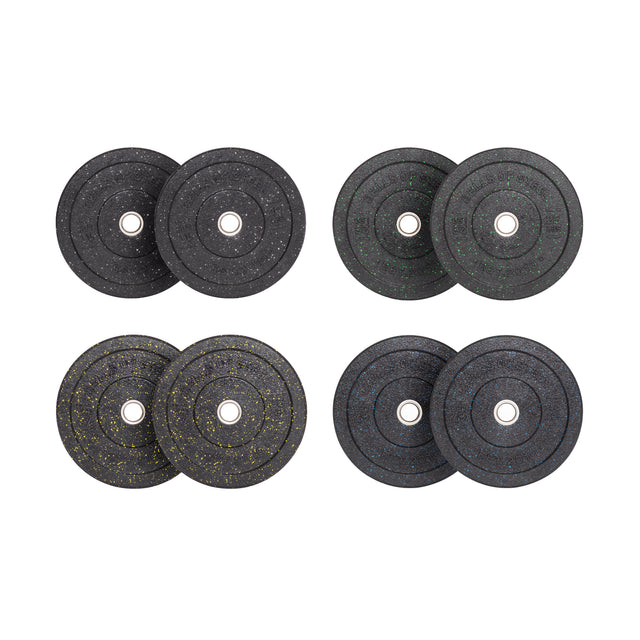Crumb Bumper Plate Sets by Bells of Steel are displayed in four pairs featuring a round, black design with white, green, yellow, and blue specks. Each pair includes a central metal hole for easy barbell mounting and is arranged on a pristine white background.