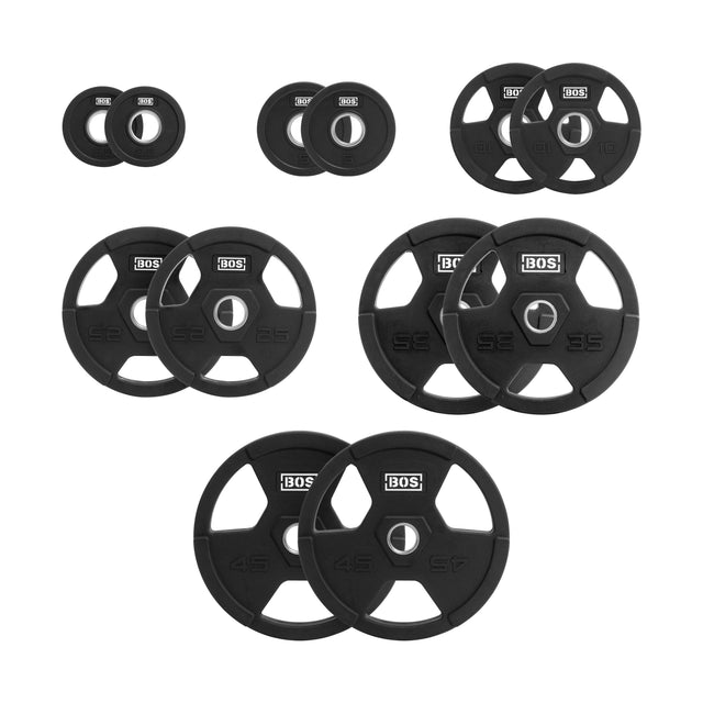 Bells of Steel's Rubber Coated Iron Weight Plate Sets are neatly arranged, featuring durable rubber for longevity and ergonomic handles for easy grip. Each plate has central barbell holes, weight labels, and the Bells of Steel logo.