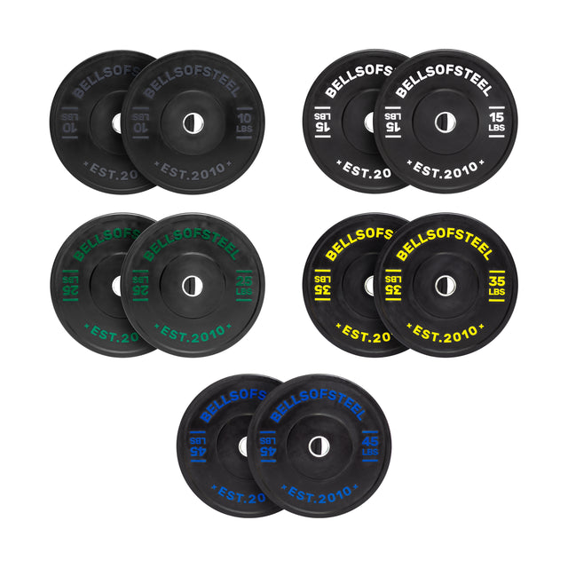 Eight pairs of Dead Bounce Conflict Bumper Plate Sets by Bells of Steel, each in a different color and weight, are arranged in two rows on a white background. Every pair has a stainless steel insert ring and colored pound markings.