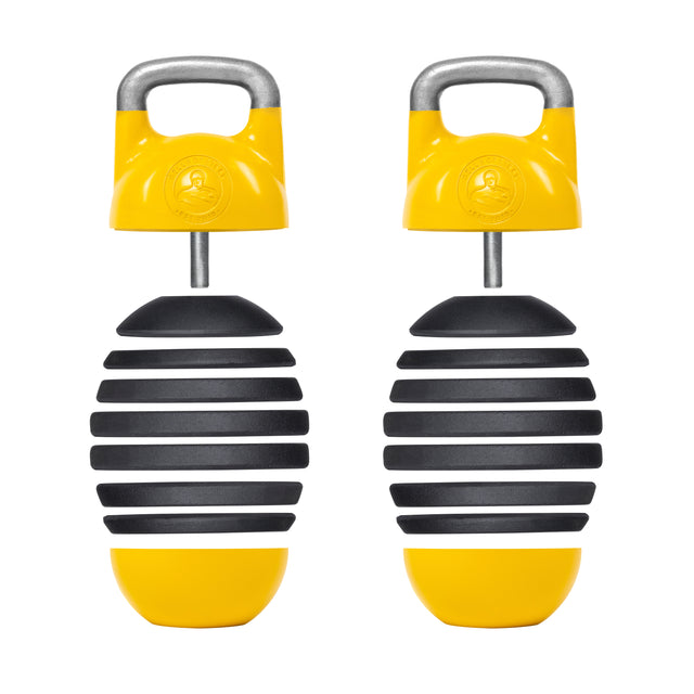 Two Adjustable Competition Kettlebells by Bells of Steel, featuring a distinctive yellow and black spherical design with handles on top, are placed side by side. Their layered construction gives them a striped, competition-style appearance ideal for kettlebell training enthusiasts.