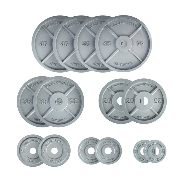 A set of gray Machined Iron Olympic Weight Plate Sets by Bells of Steel, featuring precision holes and clearly labeled with their weight in pounds, arranged neatly on a white background.