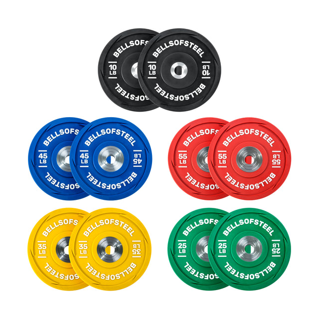 Eight vibrant Urethane Bumper Plates by Bells of Steel are symmetrically arranged: black (10 lb), red (15 lb), blue (25 lb), yellow (35 lb), and green (45 lb). Each plate has a metallic center ring and is ideal for Olympic weightlifting.