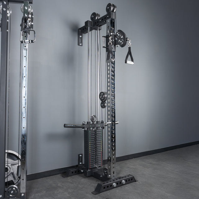 The Bells of Steel USA Oblivyon Tower - 3" x 3" Cable Tower features adjustable pulleys, weight stacks, and sturdy 3x3 uprights for stability, positioned against a gray wall in a gym with a concrete floor.