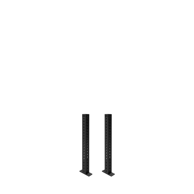 Two black Hydra Vertical Uprights by Bells of Steel, built for a 3x3 power rack, stand parallel on flat bases with multiple holes, ready for various rack attachments against a plain white background.