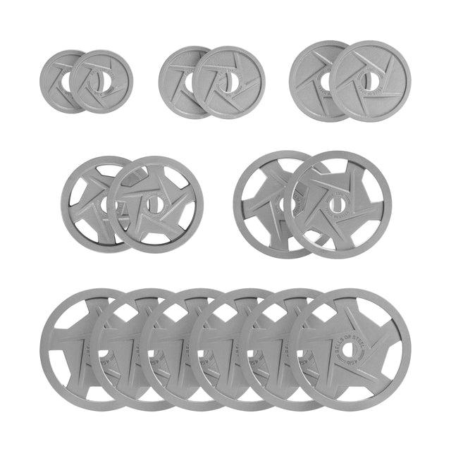 The Gray Mighty Grip Olympic Weight Plate Sets by Bells of Steel are arranged in three rows, with sizes increasing from top to bottom. Each features a circular cutout and ergonomic design, with a durable hammertone powder coat in a matte finish.