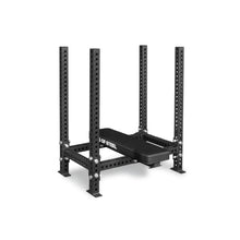 The Manticore Four Post Converter Bench by Bells of Steel USA features a black steel frame with four vertical posts, multiple adjustment holes, sturdy square base supports, and a flat padded bench labeled "OF STEEL" in white text.