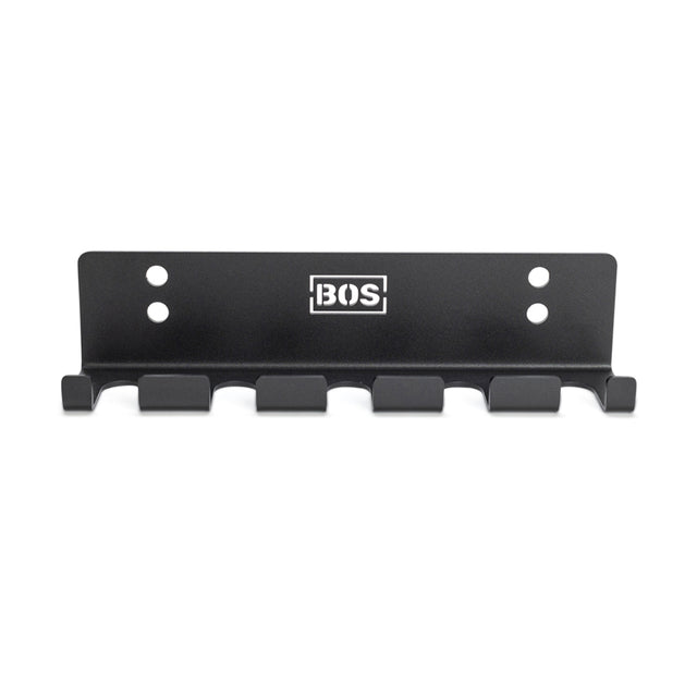 The Bells of Steel Hanging Barbell Holders is a black metal wall rack with six hooks, four screw holes for secure mounting, and a white BOS logo at the center—perfect for organizing your lifting space in style.