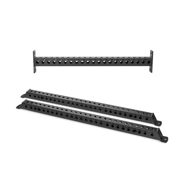 Three black metal Manticore Flat Foot Components by Bells of Steel, each with multiple circular holes, are arranged on a white background—two lying flat and one upright—suitable for power rack support systems.