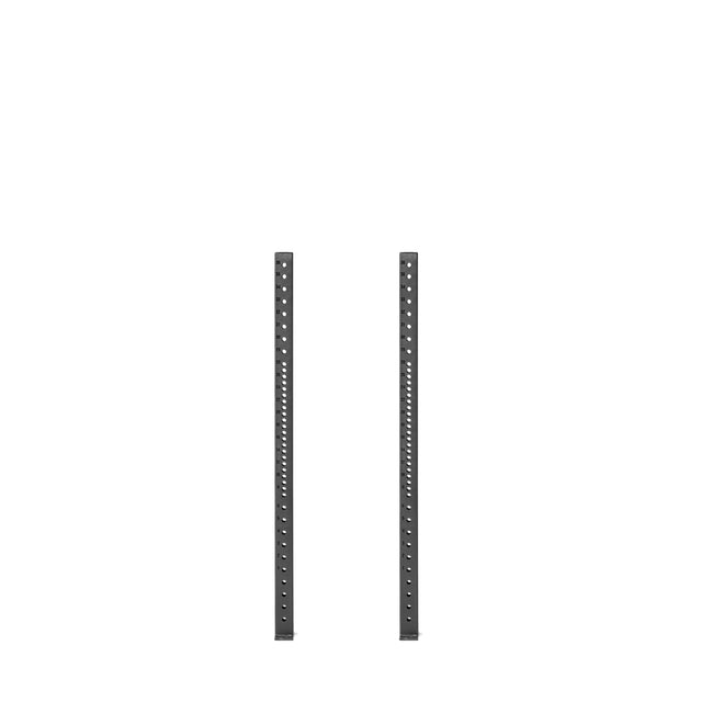 Against a white background, two vertical black metal uprights from the Bells of Steel Hydra Vertical Uprights system feature multiple evenly spaced holes along their lengths, indicating compatibility with adjustable shelving or various rack attachments.