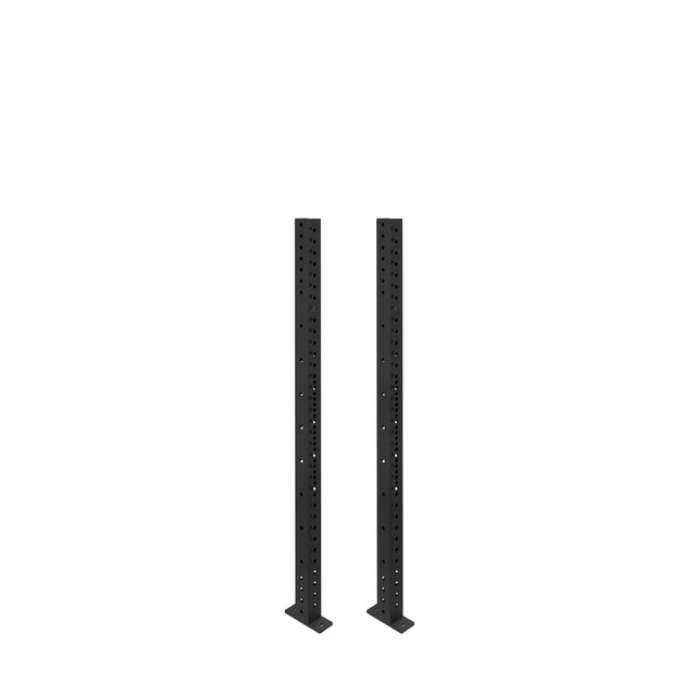 Two black Hydra Vertical Uprights by Bells of Steel, featuring evenly spaced holes and flat bases, stand parallel on a white background, ready for 3x3 power rack attachments.