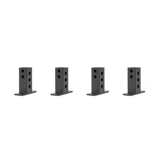 Four black, rectangular metal brackets from Bells of Steel’s Folding Rack Wall Connectors & Hinges collection are evenly spaced on a plain white background. Each bracket has multiple circular holes, perfect for wall connections or assembling a folding rack for support or mounting.