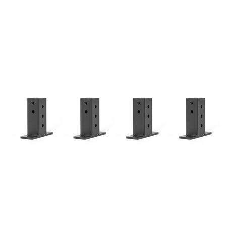 Against a white background, four black rectangular metal brackets from Bells of Steel's Folding Rack Wall Connectors & Hinges are evenly spaced. Each bracket is designed with multiple circular holes for easy wall mounting or attaching.