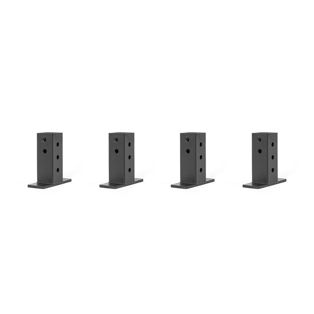 Against a white background, four black rectangular metal brackets from Bells of Steel's Folding Rack Wall Connectors & Hinges are evenly spaced. Each bracket is designed with multiple circular holes for easy wall mounting or attaching.