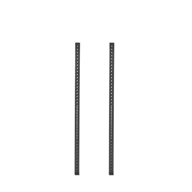 Two black Hydra Vertical Uprights from Bells of Steel stand parallel against a white background, featuring evenly spaced circular holes and reminiscent of the sturdy construction seen in Hydra Rack attachments.