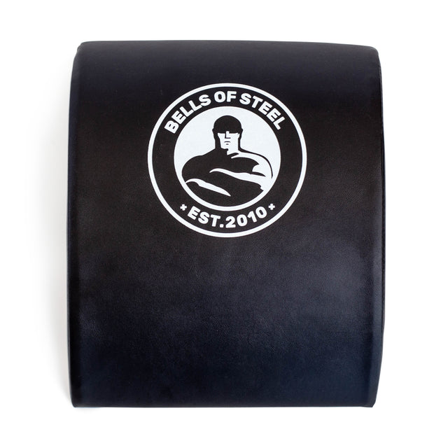 The Bells of Steel Sit Up Mat in black features a muscular figure logo and the text "Est. 2010," providing excellent lumbar support with a focus on functionality and durability in a portable design.