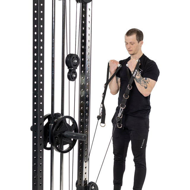 A man in black workout clothes uses the Bells of Steel Aluminum Handles Pair with a cable machine for bicep curls, pulling the handles upward against a white background.