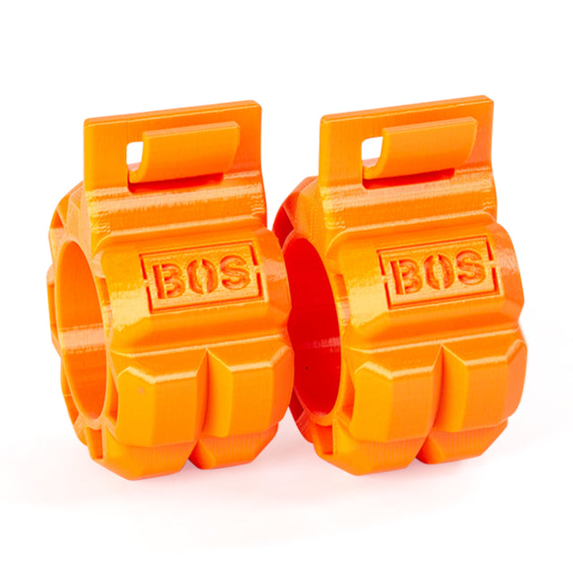 Two bright orange Barbell Zip Clips by Bells of Steel, made of plastic with "BOS" embossed on the front, feature a chunky geometric pressure-cuff design and a rectangular loop at the top of each clip.