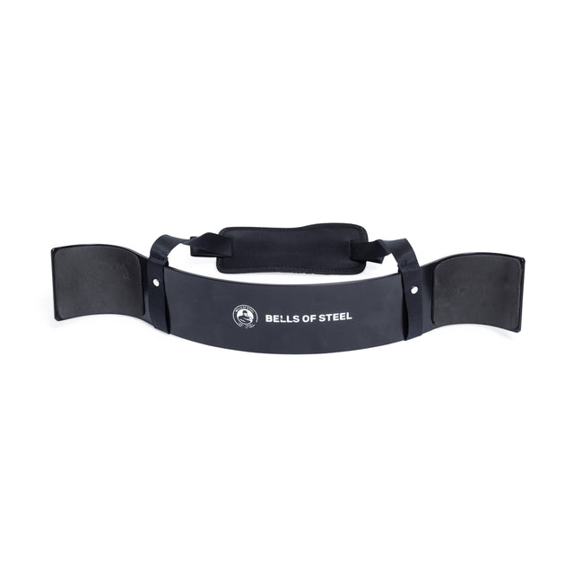 The Arm Blaster by Bells of Steel is black with a white logo, made from durable aluminum. It includes adjustable straps and a padded neck rest to maintain proper form and support your arms during workouts.