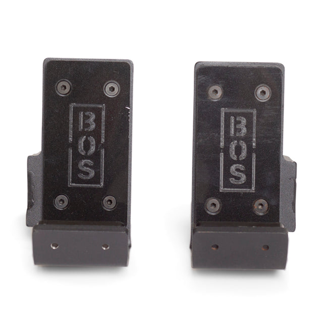 Two black metal Standard J-Cups from Bells of Steel, each with "BOS" engraved vertically in a rectangle, four visible screws, and UHMW protection to safeguard your power rack and equipment.