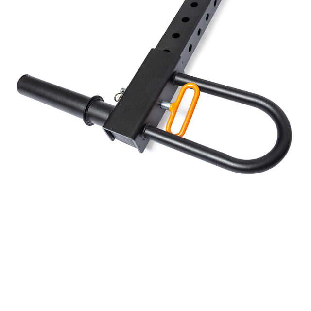 A close-up of a black metal barbell holder on the Bells of Steel Belt Squat / Lever Arms Rack Attachment, featuring circular holes. An orange carabiner and pin secure the setup. Designed for home gym enthusiasts, it extends to support seamless barbell workouts.