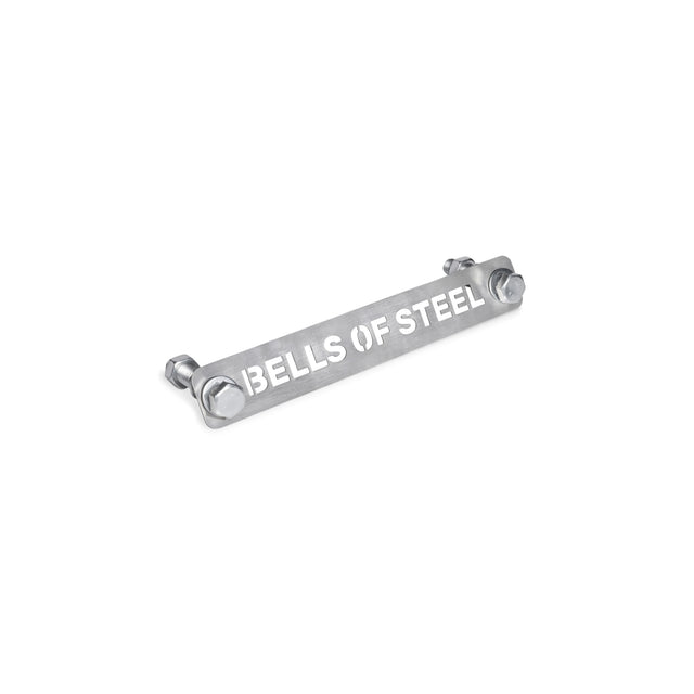 The Bells of Steel Manticore Hardware includes a rectangular silver metal plate with "BELLS OF STEEL" in white capital letters. It easily attaches to your Manticore Power Rack with two bolts on each end and comes with a hardware kit for hassle-free mounting.