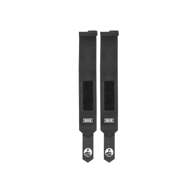 Two black Mighty Wrist Wraps by Bells of Steel, each with velcro closures, a BOS logo tag near the end, and a stylized S logo on the tip, are laid parallel on a white background—ideal wrist support for powerlifting.