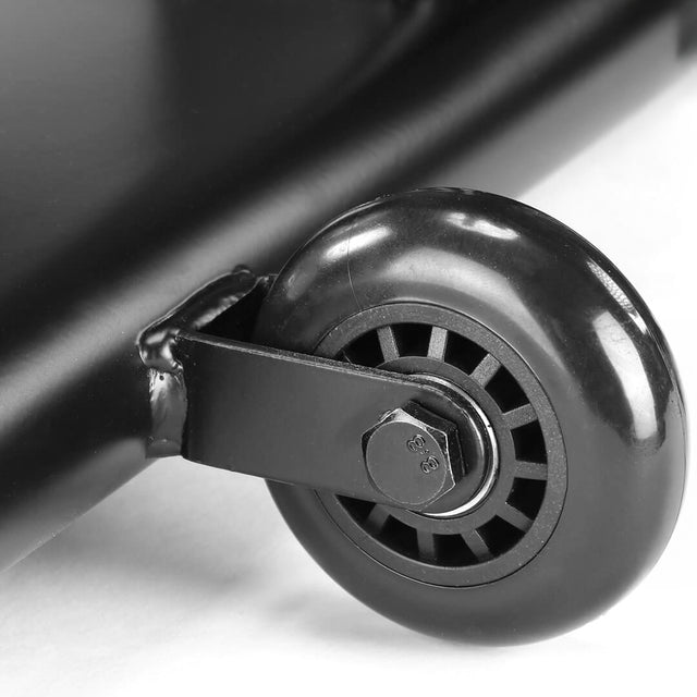 Close-up of a small black caster wheel secured with a bolt to the metal frame of the Bells of Steel Blitz Air Bike, highlighting this key home gym equipment against an out-of-focus white background.