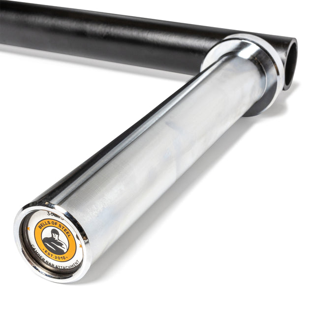 Close-up of the Bells of Steel Camber Bar Attachment - Pair, with the logo on the end cap; another black bar is partially visible in the background.