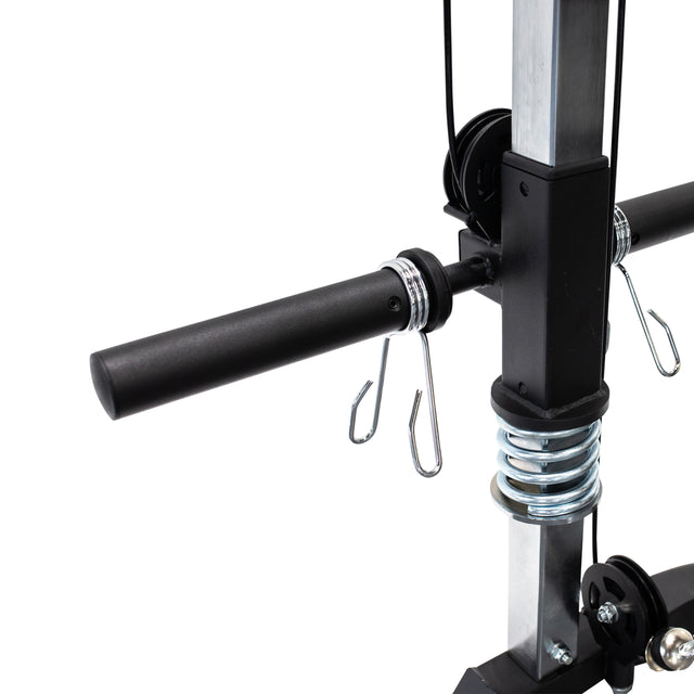 Close-up of a black and silver handle with metal hooks, pulleys, and a spring attached to the Bells of Steel Cable Crossover (2.3" x 2.3" Racks), showing its versatile pulley system on a sturdy vertical frame.