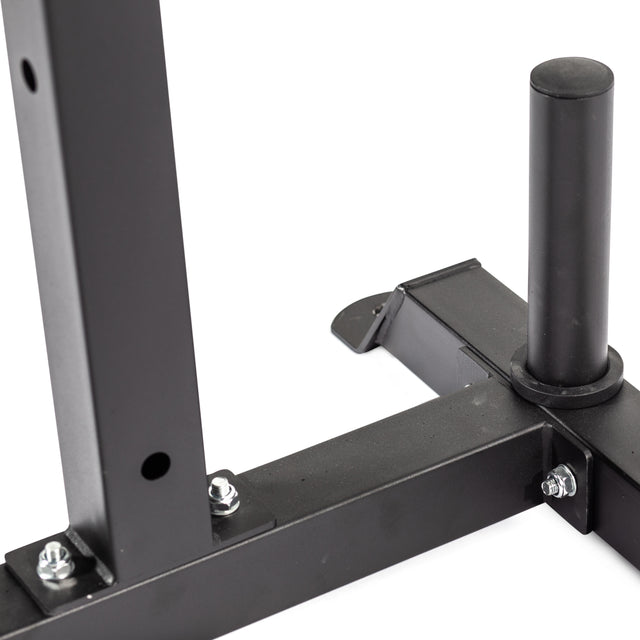 Close-up of a black metal frame with bolts, showing a vertical cylindrical post and flat horizontal support—part of the Bells of Steel Cable Crossover for 2.3" x 2.3" racks, designed as a weightlifting rack attachment for pulley systems.