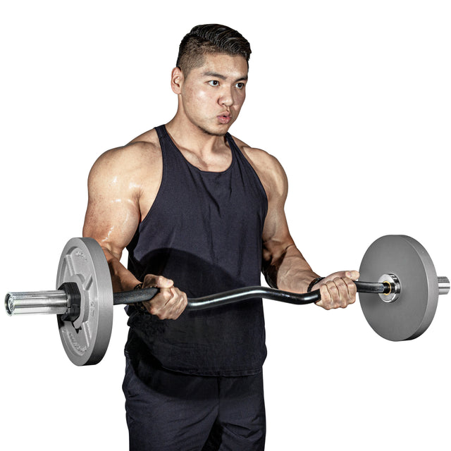 A muscular man in a black tank top and pants performs a bicep curl with a loaded barbell featuring Bells of Steel Machined Iron Olympic Weight Plate Sets against a white background.