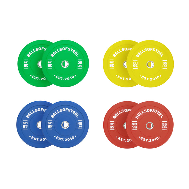 The Bells of Steel Colored Bumper Plate Sets include four pairs in green (25 lb), yellow (35 lb), blue (45 lb), and red (55 lb) with a durable stainless steel insert, each labeled “BELLS OF STEEL EST. 2010” on a white background.