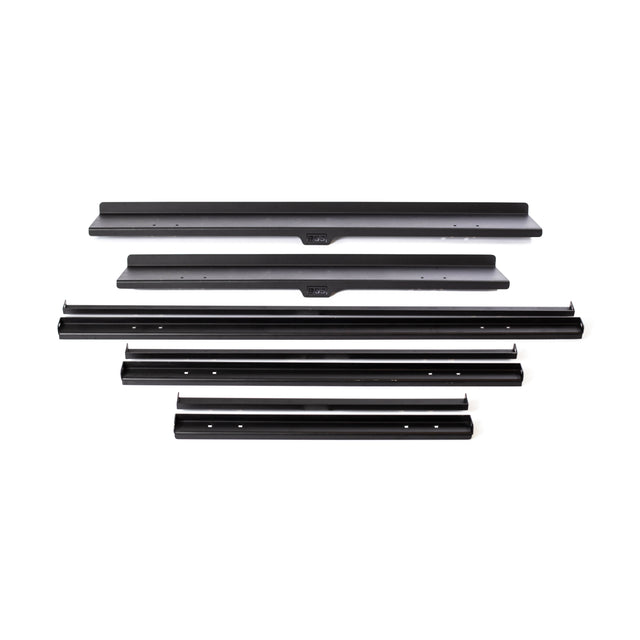 Five black metal rails of varying lengths from Bells of Steel’s Commercial Interchangeable Weight Rack - Components Only are arranged in parallel on a white background, each with mounting holes for assembling a swappable storage shelf.
