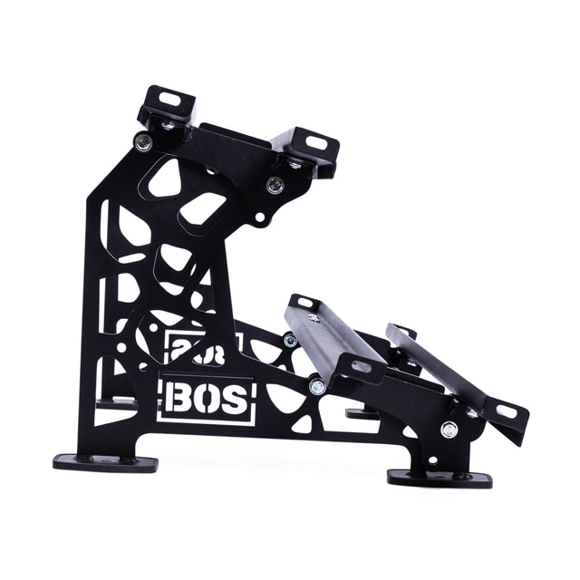 The Bells of Steel Commercial Interchangeable Weight Rack - Components Only is a black metal open-frame bracket with cutouts and angular supports, BOS logo on the side, designed for gym kettlebell storage or shelving, and assembles securely with bolts.
