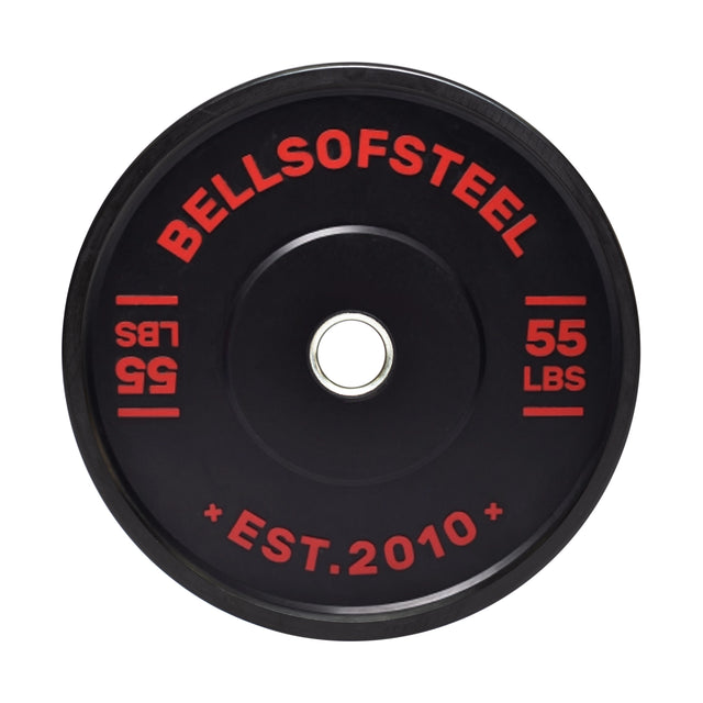 The Dead Bounce Conflict Bumper Plate by Bells of Steel is black with red text displaying "BELLS OF STEEL" and "55 LBS." and notes "EST. 2010" at the bottom. Made from virgin rubber, it features a durable stainless steel center insert.