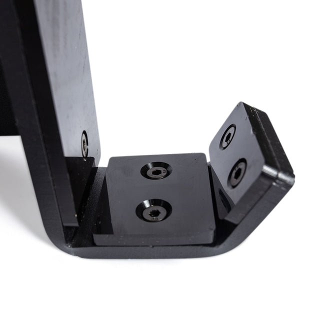 Close-up of a black metal L-shaped bracket with three screws securing the joint, like those in Bells of Steel Standard J-Cups for power racks, photographed against a white background.