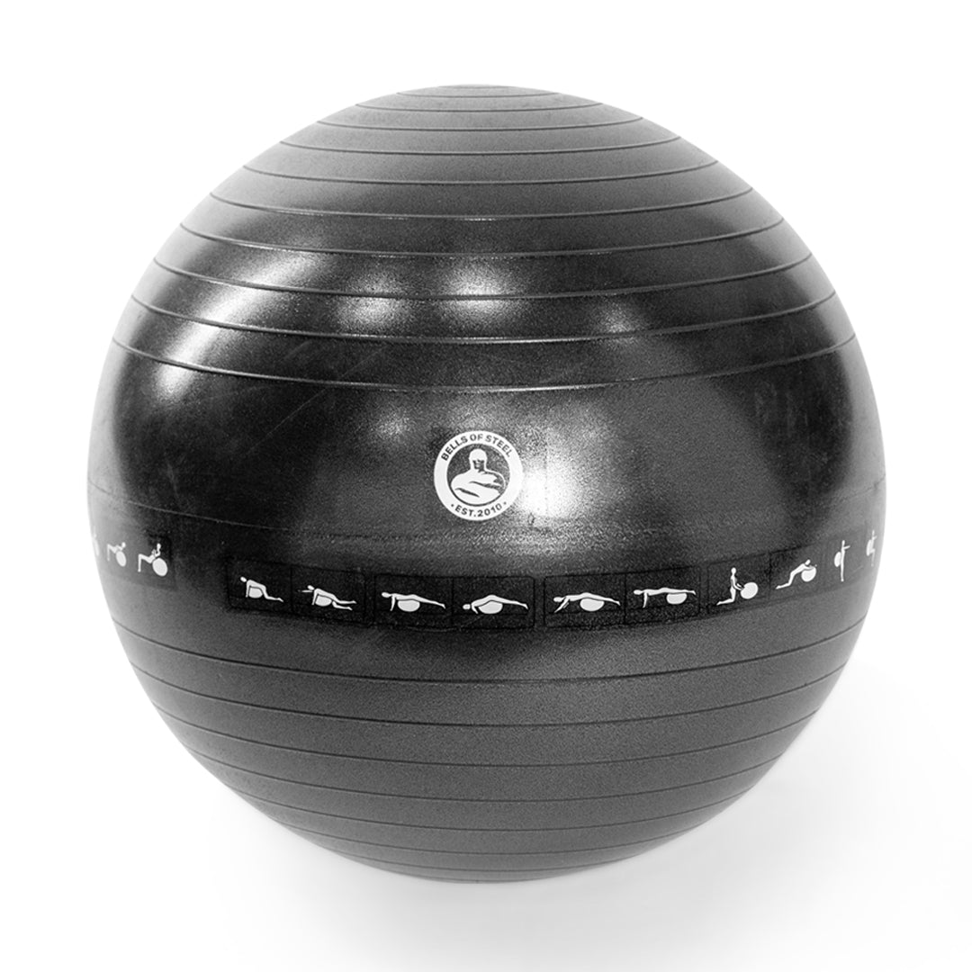 The Bells of Steel Exercise Ball is black with a textured surface and features small white workout illustrations around its center.