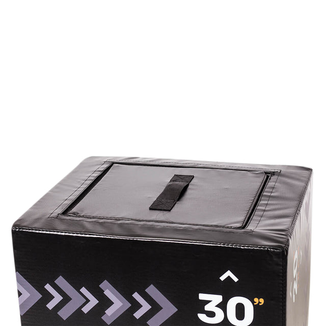 A close-up of the top corner of the Bells of Steel 6-In-1 Soft Foam Plyo Box / Squat Box shows its handle, opening flap, arrow designs, and "30" marking on the side, emphasizing its space-saving design for versatile workouts.