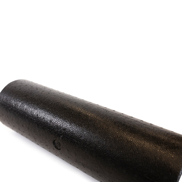 A close-up of the Bells of Steel Foam Roller, featuring a textured black design, perfect for self-myofascial release and enhancing mobility, shown lying on its side against a white background.