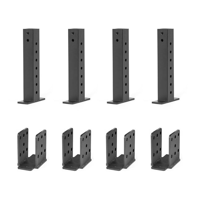The product, Folding Rack Wall Connectors & Hinges by Bells of Steel, features four black metal brackets designed for installation. These U-shaped brackets have multiple holes for secure attachment with bolts or screws to wall studs and mounting plates, ideal for folding racks or Hydra & Manticore racks.