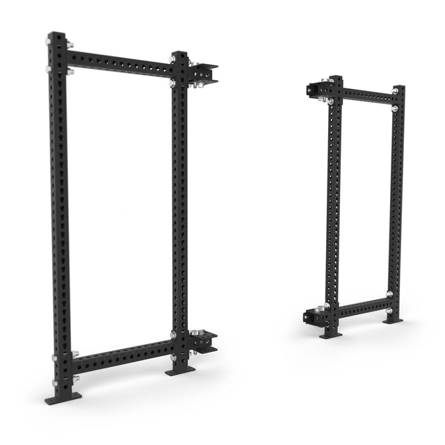 Two black Bells of Steel Manticore Folding Power Racks (prebuilt, 3"x3" uprights, 1" holes) stand upright on a white background. These sturdy racks are ideal for weightlifting or enhancing your home gym.