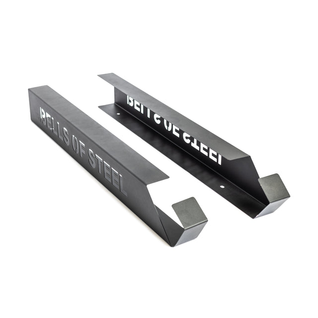 Two black metal barbell holders with angled ends and "BELLS OF STEEL" cut out on the sides, shown on a white background. Ideal to pair with Bells of Steel Foam Roller Storage for organized gym and foam roller storage.