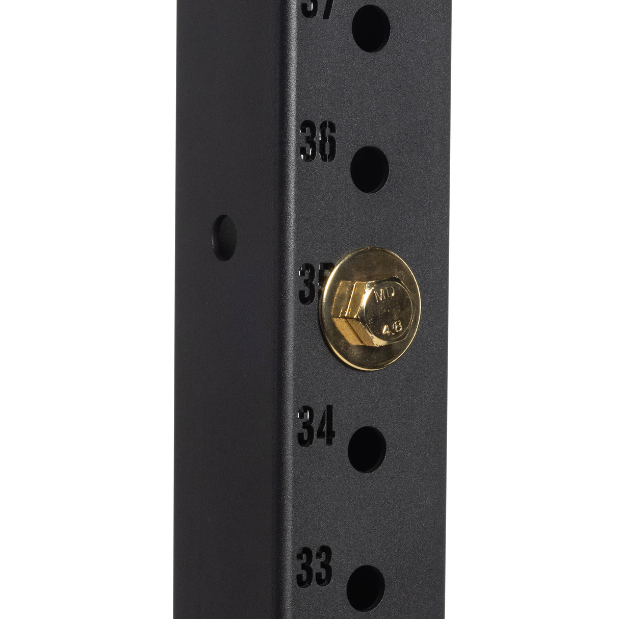 Close-up of a black metal rack with numbered holes (33–37), featuring a Bells of Steel Gold / Black Titanized Bolt for Hydra securely inserted into hole 35.