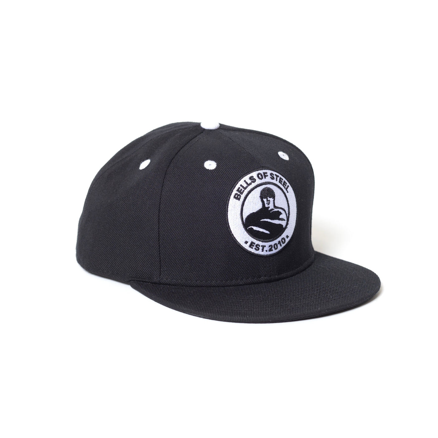 The Bells of Steel Snap Back Hat is black with a flat brim, features a circular "Bells of Steel Est. 2010" logo patch with a lifter holding a kettlebell on the front, and has white stitching on top.