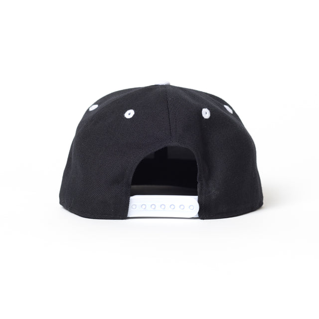 The Bells of Steel Snap Back Hat in black is shown from the back, featuring a shaded white adjustable strap and white ventilation eyelets against a plain white background.