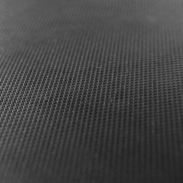 Close-up of the Hero Heavy-Duty Weight Bench by Bells of Steel shows its dark, textured surface with a fine grid pattern, highlighting durability and strength that reflect its robust max capacity.
