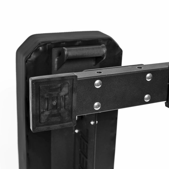 Close-up of a black padded shield with a mounted handle and bracket, showcasing durability similar to the Bells of Steel Hero Heavy-Duty Weight Bench, which features a 1,000lb max capacity. Image highlights the bracket and shield detail.