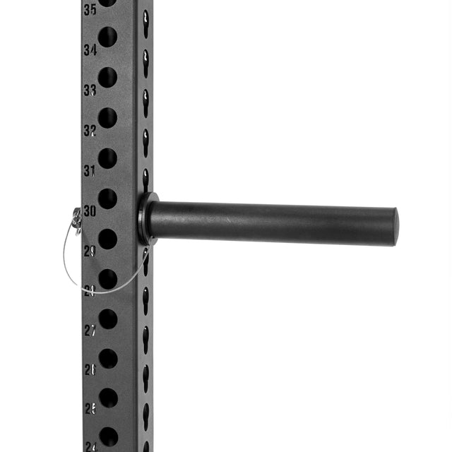 The Bells of Steel Utility Horn Rack Attachment features a black metal rack with numbered holes (21-35) on a vertical post. It includes a horizontal cylindrical peg for Olympic weight plates, secured by a pin with a wire loop, showcasing impressive rack configurations.